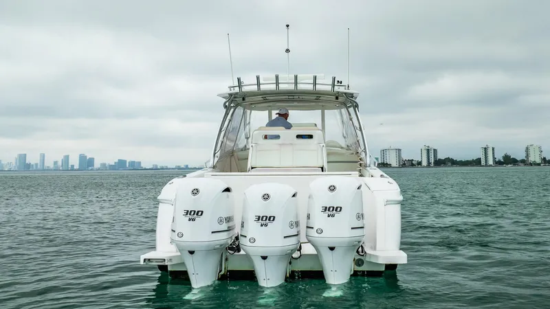 Slide: The Image of 2016 Intrepid 400 Cuddy boat with triple 300 HP engines on open water. - 24