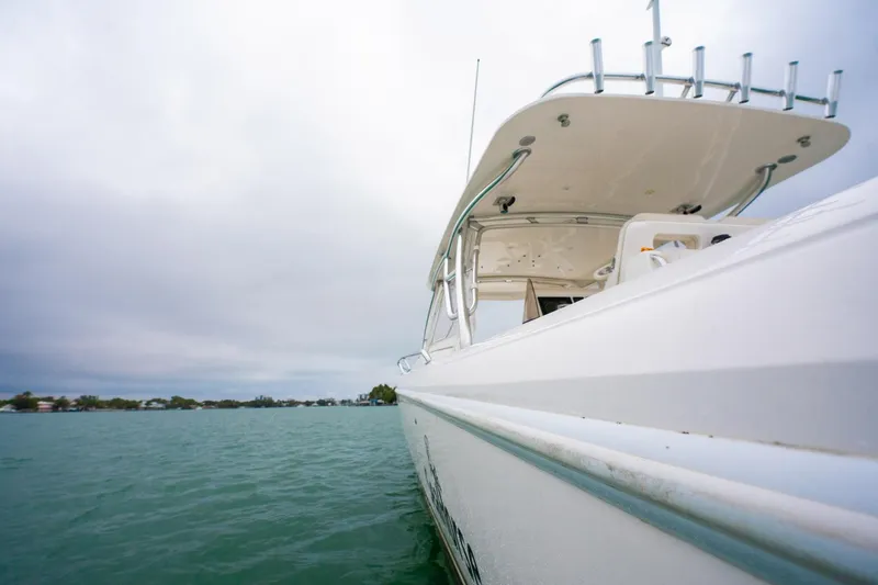 Slide: The Image of 2016 Intrepid 400 Cuddy boat on calm water under cloudy sky. - 25