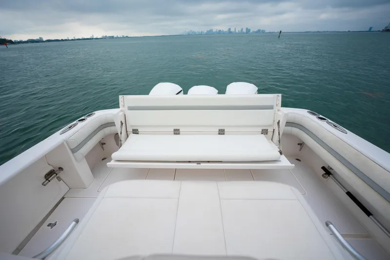 Slide: The Image of 2016 Intrepid 400 Cuddy boat, rear view, overlooking calm waters and distant skyline. - 29