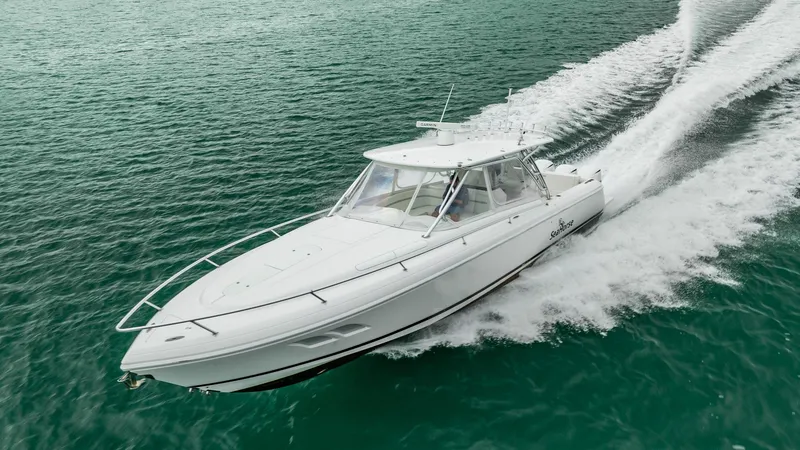Slide: The Image of 2016 Intrepid 400 Cuddy cruising on clear turquoise water. - 3