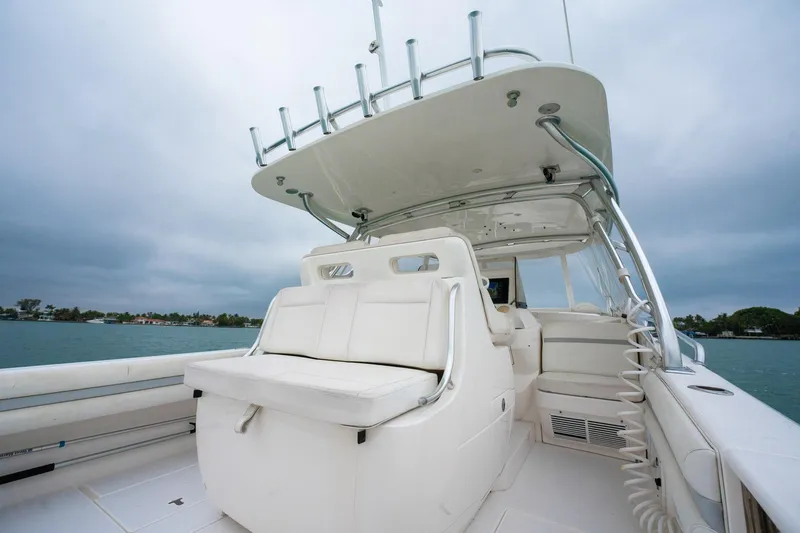 Slide: The Image of 2016 Intrepid 400 Cuddy boat with spacious seating and sleek design on open water. - 31