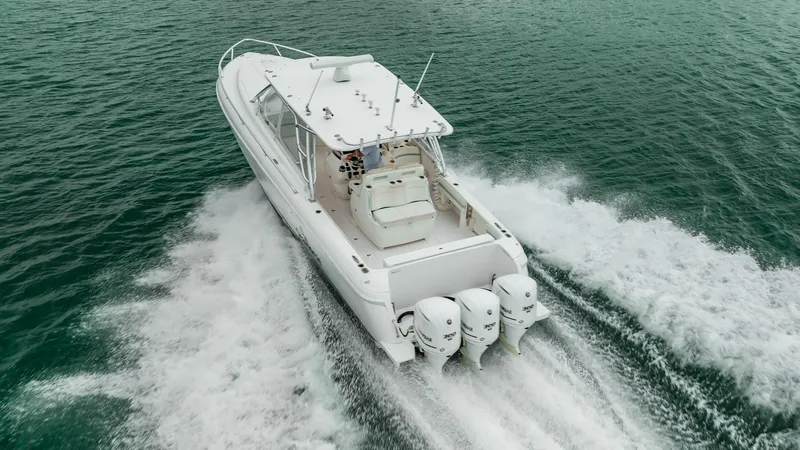 Slide: The Image of 2016 Intrepid 400 Cuddy boat cruising on open water, rear view. - 4