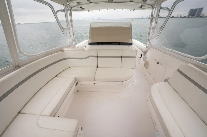 Slide: The Image of 2016 Intrepid 400 Cuddy boat interior with white seating and ocean view. - 41