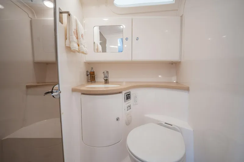 Slide: The Image of 2016 Intrepid 400 Cuddy bathroom with modern fixtures, white cabinetry, and compact design. - 47