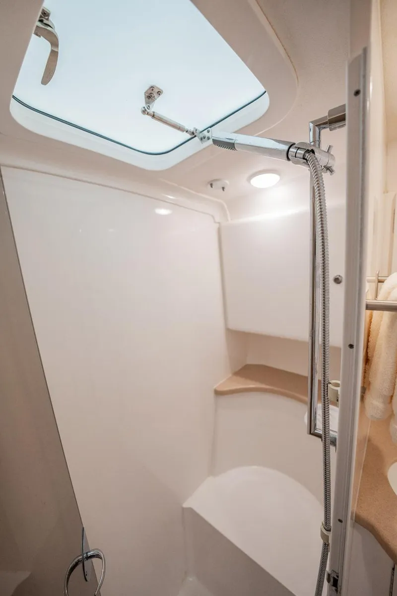 Slide: The Image of 2016 Intrepid 400 Cuddy boat bathroom with skylight and modern fixtures. - 48