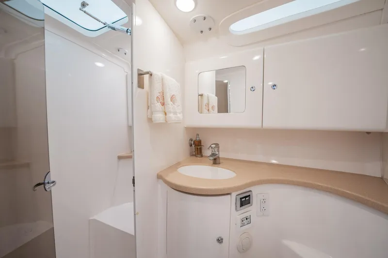 Slide: The Image of 2016 Intrepid 400 Cuddy bathroom with modern fixtures and sleek design. - 49