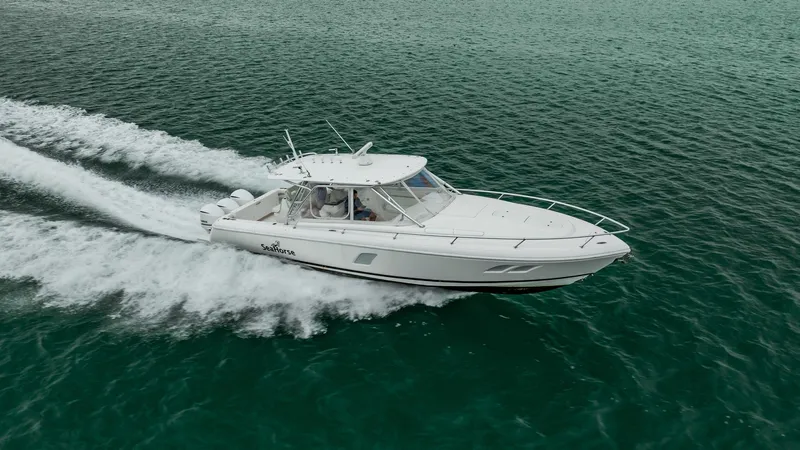 Slide: The Image of 2016 Intrepid 400 Cuddy cruising on open water, showcasing sleek design and performance. - 5