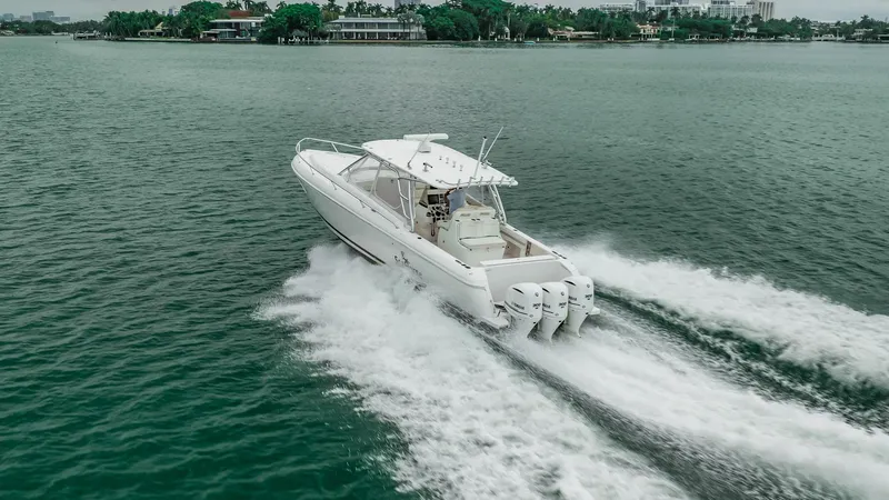 Slide: The Image of 2016 Intrepid 400 Cuddy cruising on open water, showcasing powerful engines and sleek design. - 8