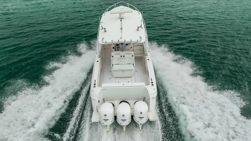 Slide: The Image of 2016 Intrepid 400 Cuddy boat cruising on open water, rear view. - 9