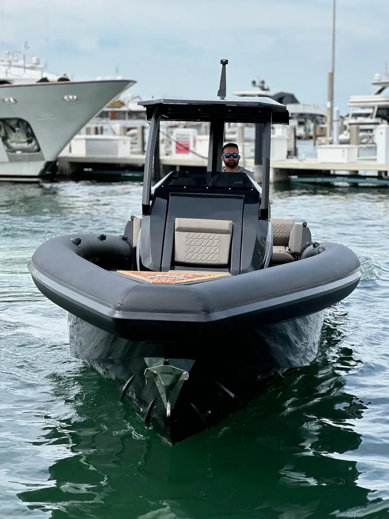 Slide: The Image of 2025 Skipper-BSK 34 boat docked in marina, sleek design, calm water, modern features. - 11