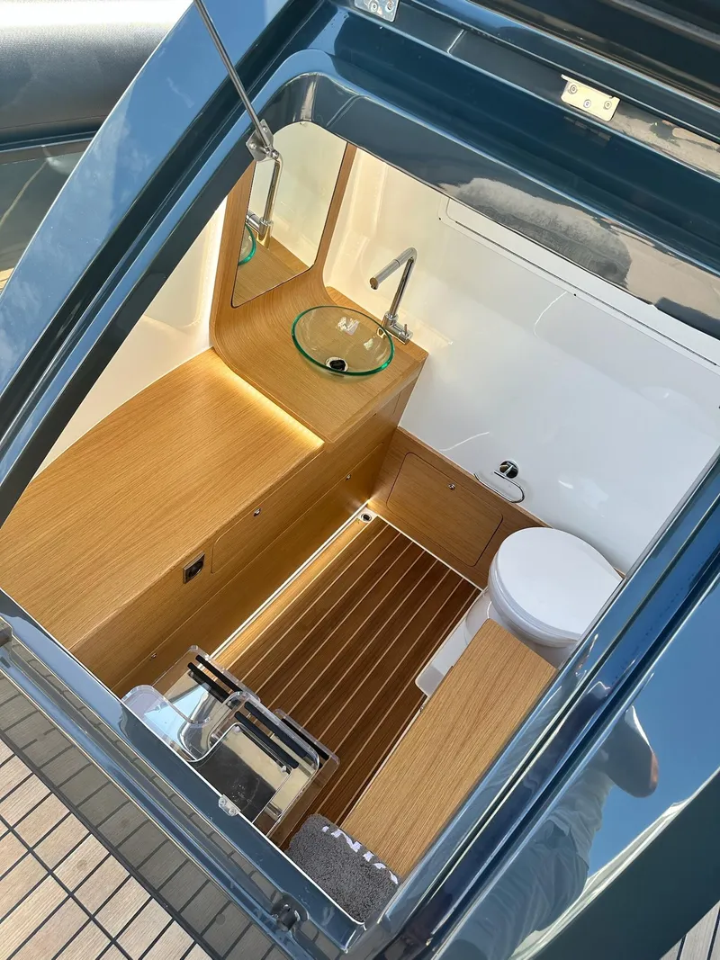 Slide: The Image of Modern Skipper-BSK 34 boat interior with wooden flooring and compact bathroom, 2025 model. - 15