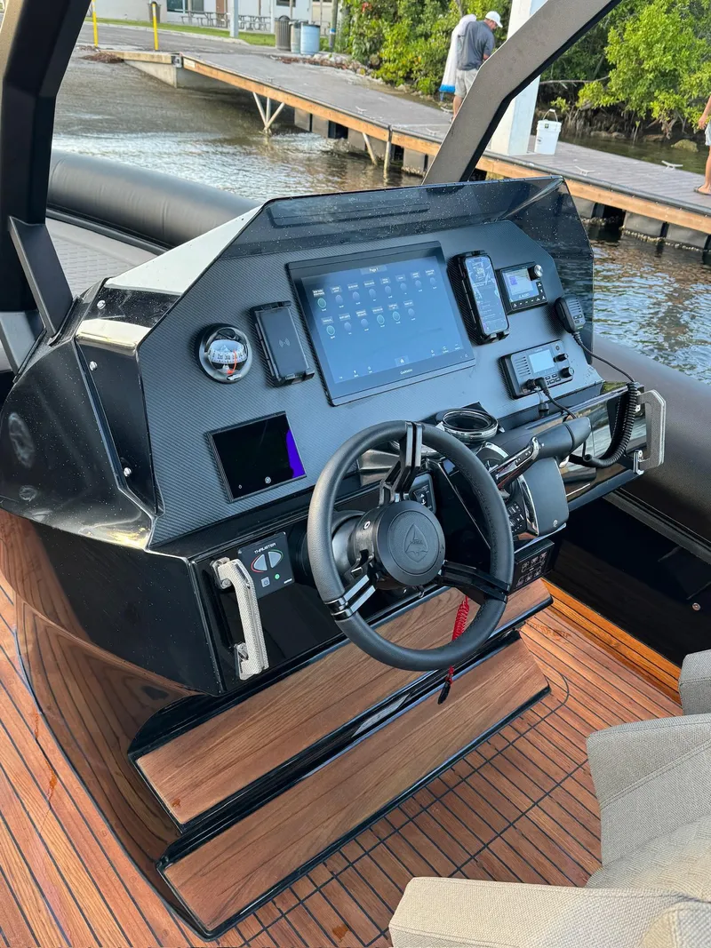 Slide: The Image of 2025 Skipper-BSK 34 boat dashboard with advanced navigation controls and sleek design. - 19