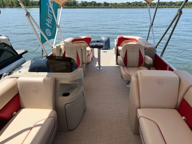 Slide: The Image of 2025 Godfrey SWEETWATER 2286 SB pontoon boat with beige and red seating on a lake. - 3