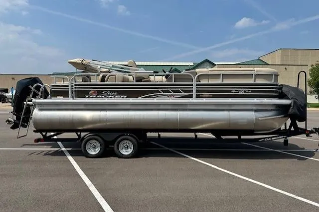 The Image of 2023 Sun Tracker SportFish 22 XP3 pontoon boat on trailer in parking lot. - 0