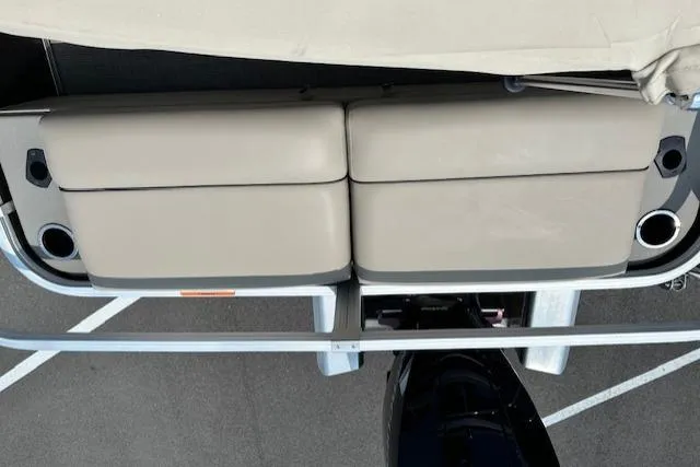 Slide: The Image of 2023 Sun Tracker SportFish 22 XP3 boat interior with beige seating and cup holders. - 10