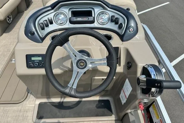 Slide: The Image of 2023 Sun Tracker SportFish 22 XP3 boat dashboard with steering wheel and controls. - 5