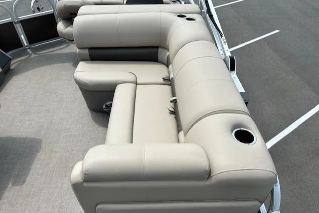 Slide: The Image of 2023 Sun Tracker SportFish 22 XP3 boat with beige seating and cup holders. - 6