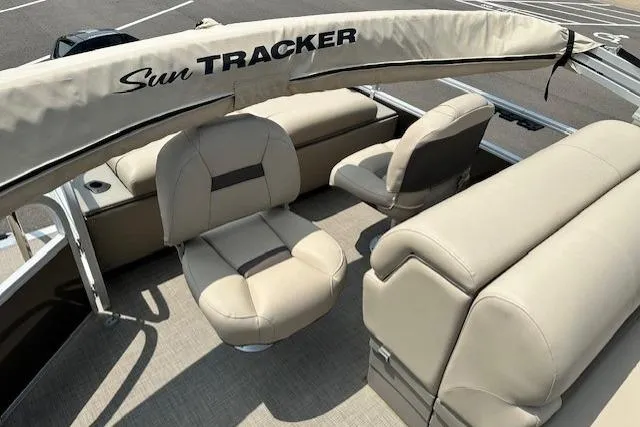 Slide: The Image of 2023 Sun Tracker SportFish 22 XP3 boat interior with beige seating and canopy. - 9