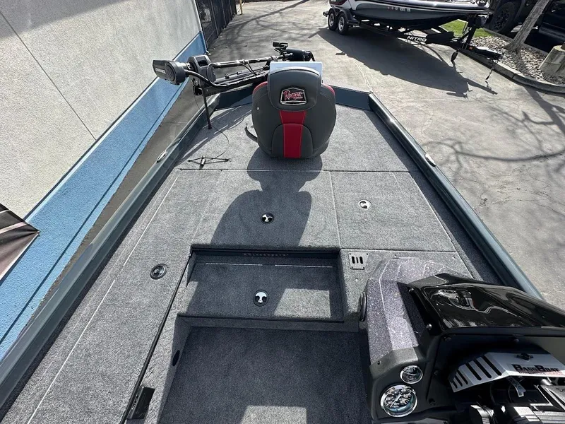 Slide: The Image of 2025 Ranger RT178 boat interior with gray carpet and seating. - 18