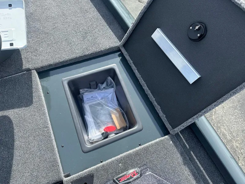 Slide: The Image of 2025 Ranger RT178 storage compartment with carpeted interior and secure latch. - 28