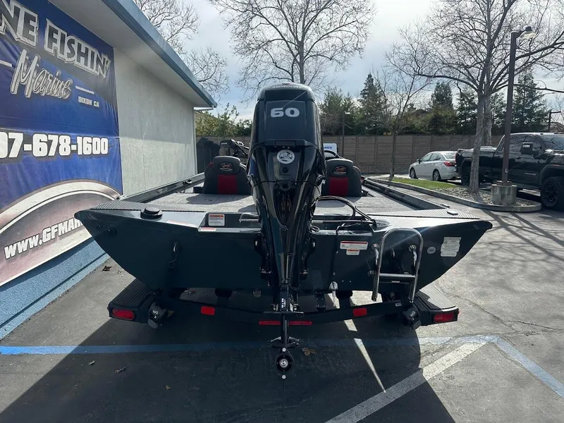 Slide: The Image of 2025 Ranger RT178 boat with 60 HP motor, parked outdoors. - 9