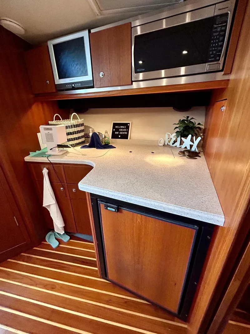 Slide: The Image of 2007 TIARA 36 OPEN yacht kitchen with microwave, TV, and compact fridge. - 10