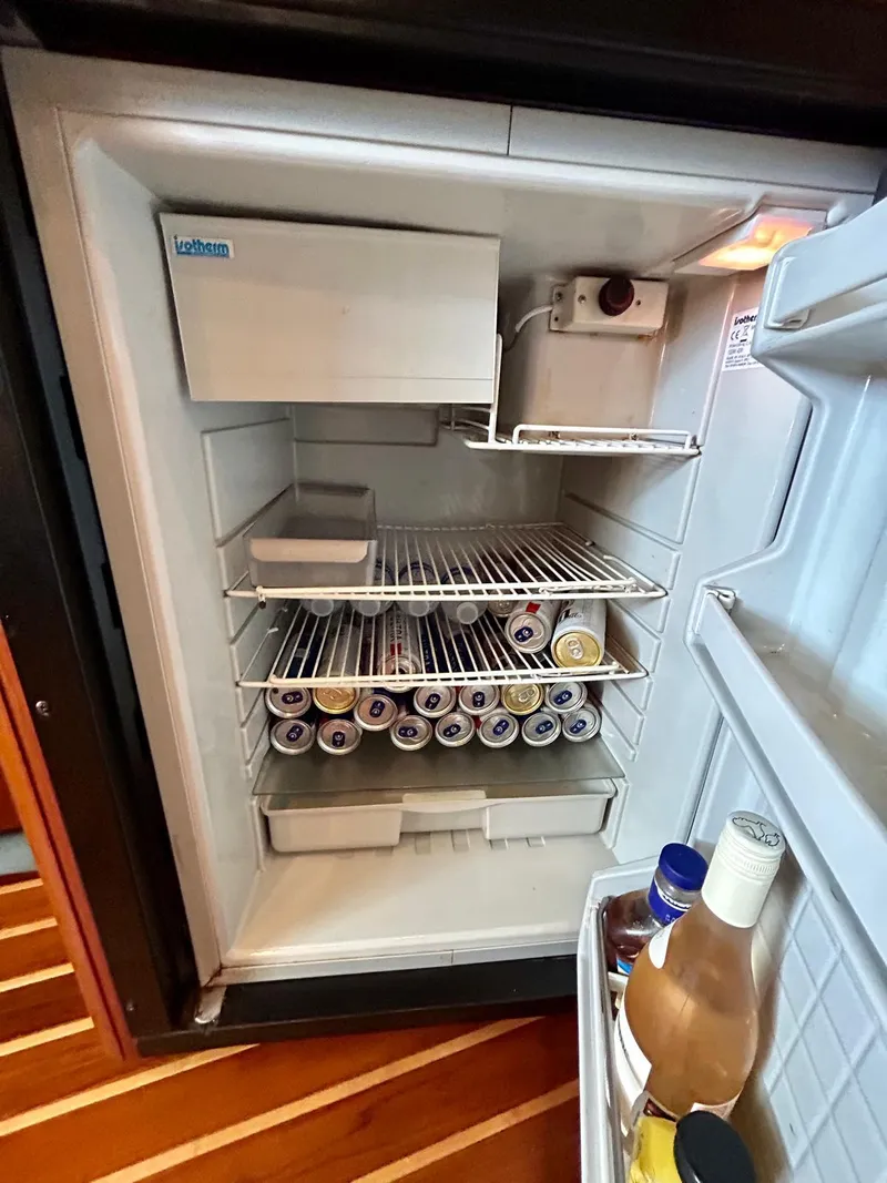 Slide: The Image of Open refrigerator on 2007 TIARA 36 OPEN boat, stocked with beverages and condiments. - 15