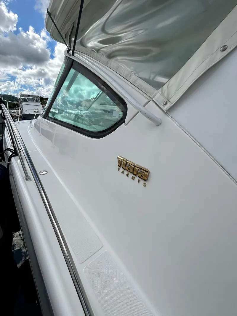 Slide: The Image of 2007 TIARA 36 OPEN boat side view with logo, under cloudy sky. - 17