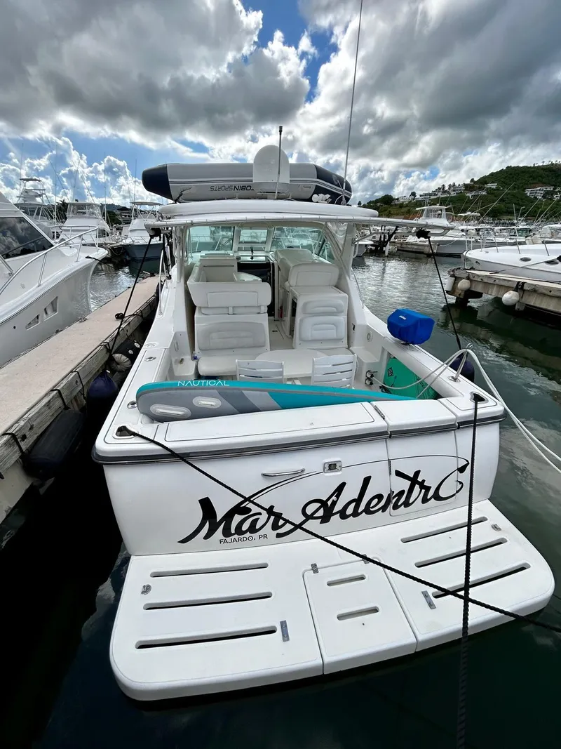 Slide: The Image of 2007 Open TIARA 36 yacht docked at marina under cloudy sky. - 21