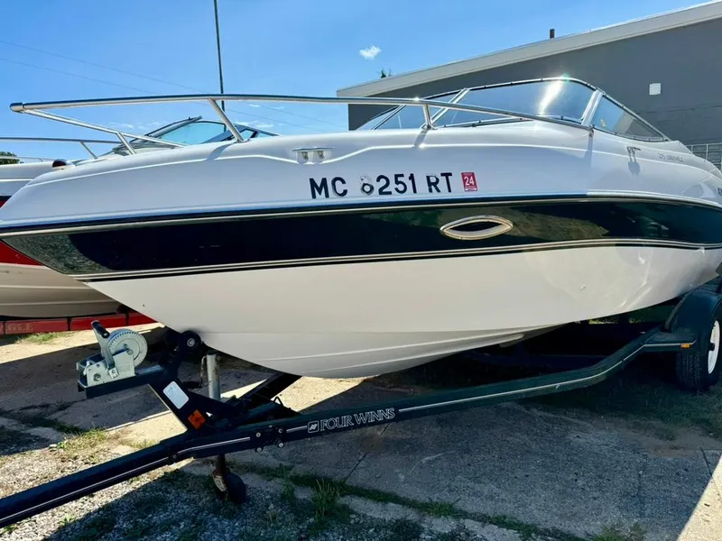 The Image of 1998 Four Winns Sundowner 205 boat on trailer, white hull, outdoor setting. - 1