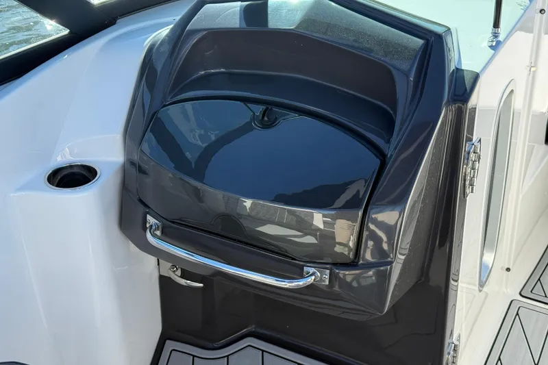 Slide: The Image of 2025 Monterey M4 boat dashboard with sleek black finish and chrome handle. - 11