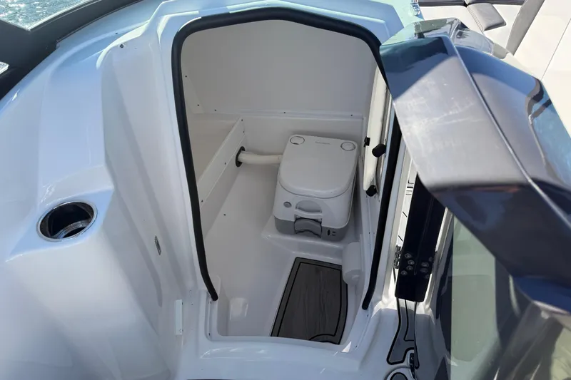 Slide: The Image of 2025 Monterey M4 boat interior with compact marine toilet and sleek design. - 12