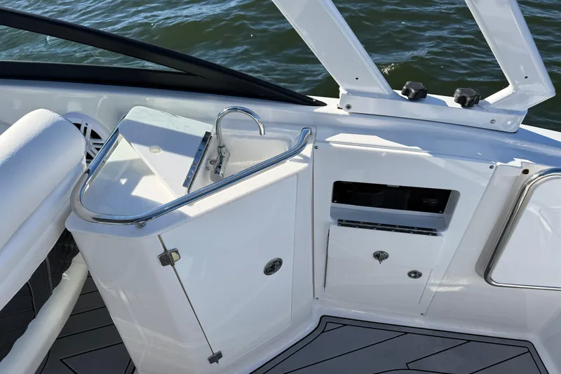 Slide: The Image of 2025 Monterey M4 boat interior with sleek sink and storage, overlooking water. - 19