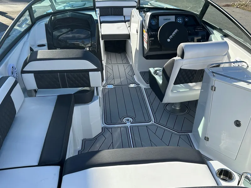 Slide: The Image of 2025 Monterey M4 boat cruising on a lake with forested shoreline. - 2