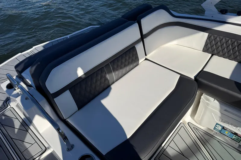 Slide: The Image of 2025 Monterey M4 boat with luxurious black and white seating on the water. - 20