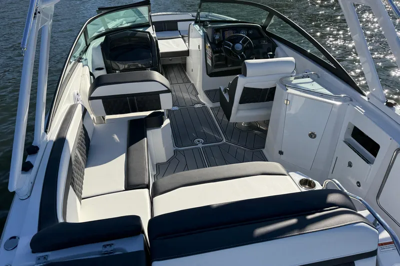 Slide: The Image of 2025 Monterey M4 boat interior with luxurious seating and modern dashboard on the water. - 22