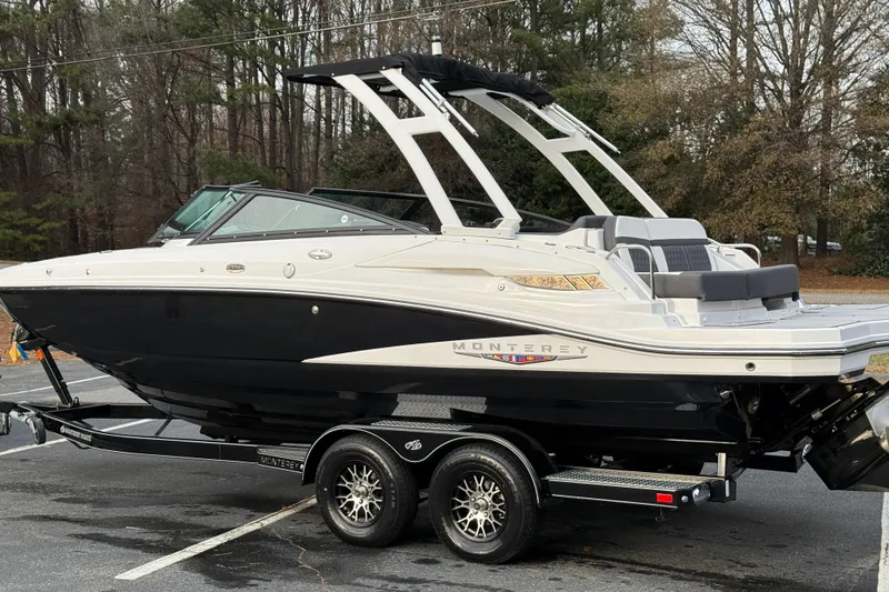 Slide: The Image of 2025 Monterey M4 boat on trailer, sleek design, parked outdoors. - 26