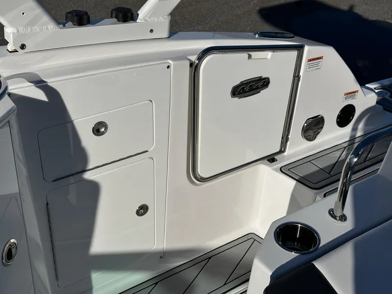 Slide: The Image of 2025 Monterey M4 boat cruising on a scenic lake with houses in the background. - 5