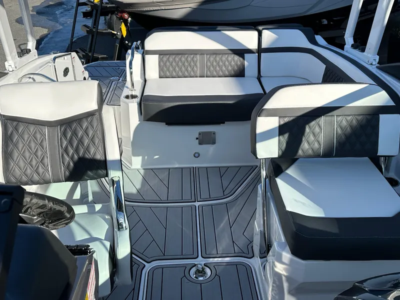 Slide: The Image of 2025 Monterey M4 boat cruising on a lake with forested shoreline. - 6