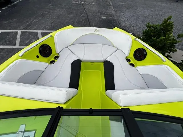 Slide: The Image of 2018 MasterCraft XT20 boat with lime green and white seating. - 14