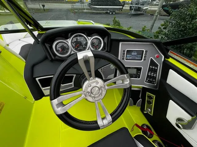 Slide: The Image of 2018 MasterCraft XT20 boat dashboard with steering wheel and control panel. - 15