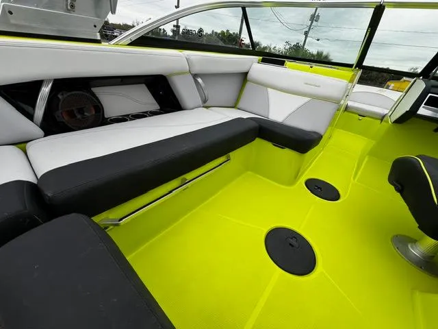 Slide: The Image of 2018 MasterCraft XT20 boat interior with vibrant lime green and black seating. - 18