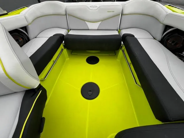 Slide: The Image of 2018 MasterCraft XT20 boat interior with vibrant lime green flooring and white seating. - 20