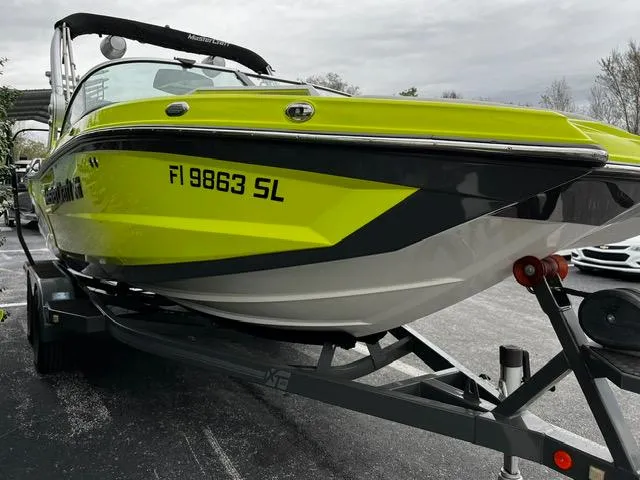 Slide: The Image of 2018 MasterCraft XT20 boat in vibrant yellow on a trailer. - 4