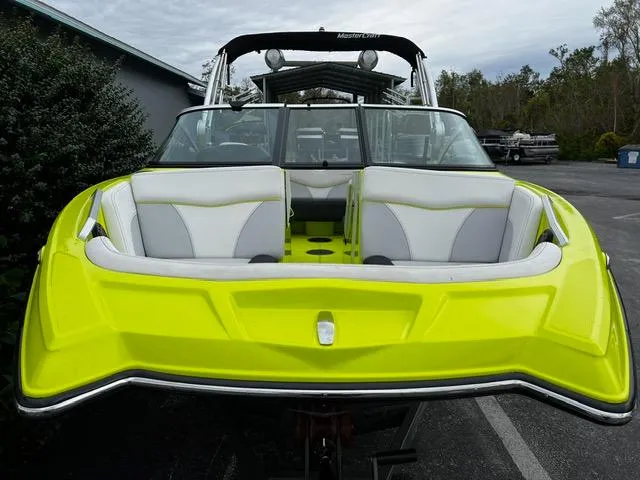 Slide: The Image of 2018 MasterCraft XT20 boat with vibrant yellow exterior and sleek design. - 6