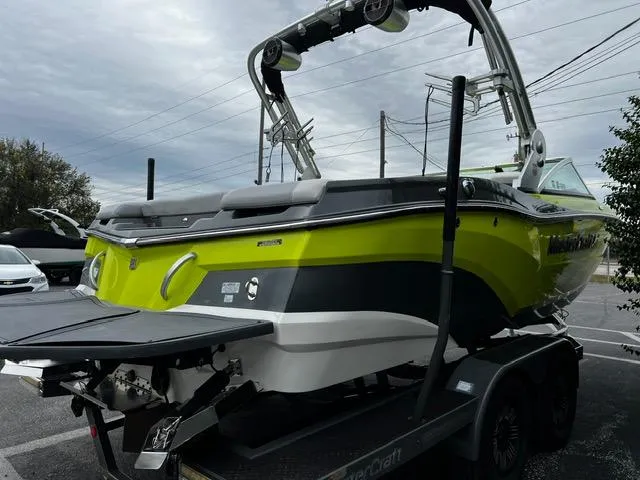 Slide: The Image of 2018 MasterCraft XT20 boat in vibrant green on a trailer, ready for transport. - 8