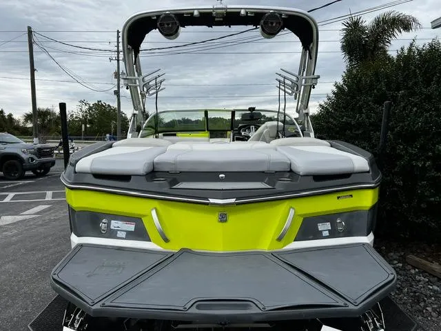 Slide: The Image of 2018 MasterCraft XT20 boat with vibrant green and gray design, parked outdoors. - 9
