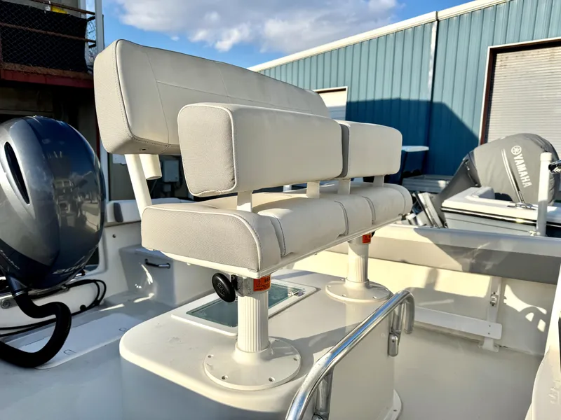 Slide: The Image of 2020 Parker 2300 Special Edition boat seating with Yamaha engine in marina setting. - 14