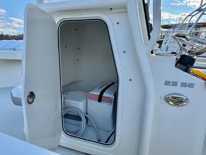 Slide: The Image of 2020 Parker 2300 Special Edition boat storage compartment with open door. - 18