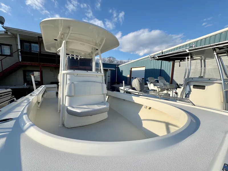 Slide: The Image of 2020 Parker 2300 Special Edition boat with seating, docked under a clear blue sky. - 20